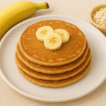 Easy banana oats pancakes for babies cut into finger-friendly strips on a colorful plate, perfect for baby led weaning and first foods