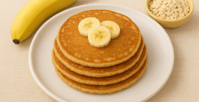 Easy banana oats pancakes for babies cut into finger-friendly strips on a colorful plate, perfect for baby led weaning and first foods